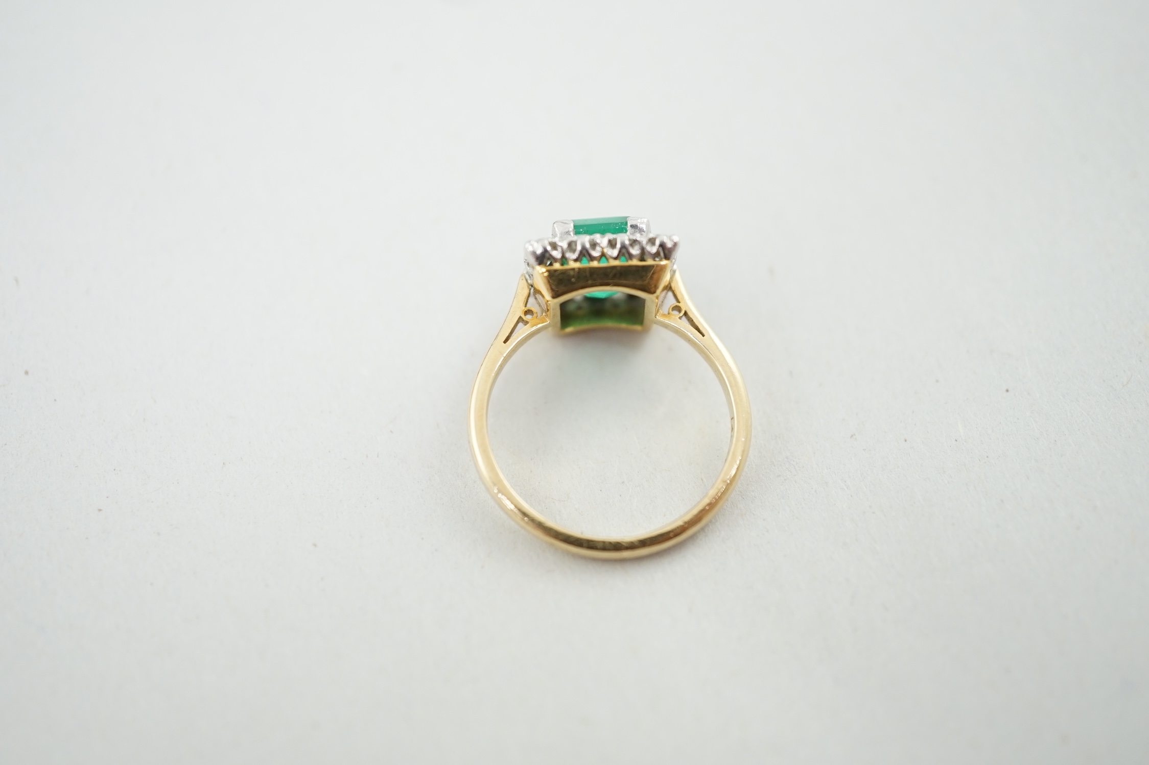 An 18ct gold and platinum, emerald and diamond set square cluster ring